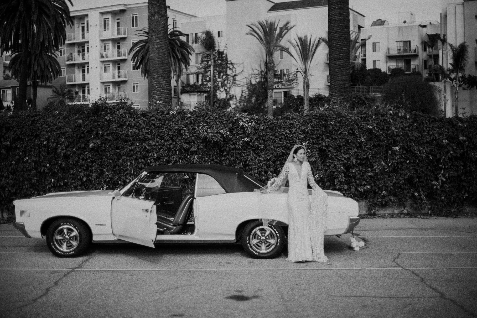 bride waiting next to her white car